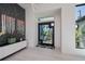 Bright foyer features tile floors, modern artwork, and a decorative front door, creating an inviting entrance at 1230 Royal Tern Dr, Punta Gorda, FL 33950