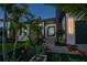 Eye-catching front entrance with modern design, manicured landscaping and decorative black metal door at 1230 Royal Tern Dr, Punta Gorda, FL 33950