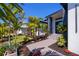 Contemporary home showcasing meticulous landscaping, modern architectural elements, and a welcoming entrance at 1230 Royal Tern Dr, Punta Gorda, FL 33950