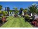 Beautifully landscaped front yard with vibrant plants and meticulously maintained lawn leading to the modern home's entrance at 1230 Royal Tern Dr, Punta Gorda, FL 33950