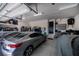 View of a well-lit garage space with overhead storage, a car, and access door at 1230 Royal Tern Dr, Punta Gorda, FL 33950