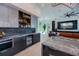 Open-concept kitchen seamlessly connected to the living area with modern appliances and a bar area at 1230 Royal Tern Dr, Punta Gorda, FL 33950