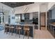 Contemporary kitchen with stainless steel appliances, a large island with seating, and unique lighting at 1230 Royal Tern Dr, Punta Gorda, FL 33950