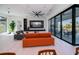 Modern living room featuring sleek furniture, light wood floors, and a wall of glass doors at 1230 Royal Tern Dr, Punta Gorda, FL 33950