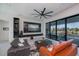 Modern living room with a large TV, stylish sofas, and sliding glass doors to the patio at 1230 Royal Tern Dr, Punta Gorda, FL 33950