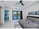Main bedroom with doors to the pool, a gray rug, trey ceilings, and contemporary decor at 1230 Royal Tern Dr, Punta Gorda, FL 33950