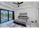 Bright main bedroom featuring a trey ceiling, ceiling fan, and sliding doors leading to the pool at 1230 Royal Tern Dr, Punta Gorda, FL 33950