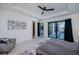 Bedroom featuring gray floors, trey ceiling, ceiling fan, and sliding doors with pool views at 1230 Royal Tern Dr, Punta Gorda, FL 33950