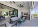 Covered patio with outdoor kitchen, grill, and comfortable seating area at 1230 Royal Tern Dr, Punta Gorda, FL 33950