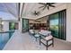 Inviting outdoor patio with comfortable seating, overlooking a stunning pool area and lush landscaping at 1230 Royal Tern Dr, Punta Gorda, FL 33950