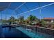 Beautiful in-ground pool with a tiled waterfall and spa in a screened in lanai at 1230 Royal Tern Dr, Punta Gorda, FL 33950