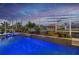 Beautiful in-ground pool and spa with colorful LED lighting at dusk at 1230 Royal Tern Dr, Punta Gorda, FL 33950