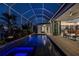 Stunning in-ground pool illuminated at night, creating a captivating and serene ambiance at 1230 Royal Tern Dr, Punta Gorda, FL 33950