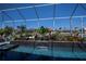 Beautiful in-ground pool with a tiled waterfall and spa in a screened lanai at 1230 Royal Tern Dr, Punta Gorda, FL 33950
