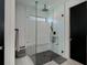 Bright shower featuring a rain shower head, hand held wand, gray flooring, and bench seating at 1230 Royal Tern Dr, Punta Gorda, FL 33950