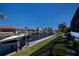 Waterfront property featuring boatlift with seawall and a neatly manicured lawn at 1230 Royal Tern Dr, Punta Gorda, FL 33950