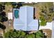 Drone view of home, in-ground pool, and surrounding trees at 16249 Ashland Ave, Port Charlotte, FL 33954