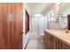 Bright bathroom with a shower-tub combo, single sink vanity, and white tile flooring at 16249 Ashland Ave, Port Charlotte, FL 33954
