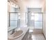 Bathroom featuring a shower-tub combo with sliding doors, a single sink vanity, and tile floors at 16249 Ashland Ave, Port Charlotte, FL 33954