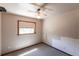Bedroom with a ceiling fan, a window, carpeted floors, and beige walls at 16249 Ashland Ave, Port Charlotte, FL 33954