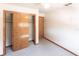 Bedroom with a ceiling fan, closet with sliding doors, carpeted floors, and beige walls at 16249 Ashland Ave, Port Charlotte, FL 33954