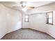 Bedroom with a ceiling fan, two windows, carpeted floors, and light-colored walls at 16249 Ashland Ave, Port Charlotte, FL 33954