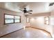 Bedroom with a ceiling fan, multiple windows, wood flooring, and neutral paint at 16249 Ashland Ave, Port Charlotte, FL 33954