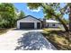Charming single-story home featuring an attached two-car garage and a concrete driveway at 16249 Ashland Ave, Port Charlotte, FL 33954