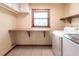 Bright laundry room with storage and counterspace at 16249 Ashland Ave, Port Charlotte, FL 33954
