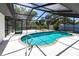 Inviting in-ground pool surrounded by a screened enclosure offering relaxation and privacy at 16249 Ashland Ave, Port Charlotte, FL 33954