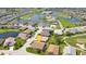 Aerial view of home in a scenic golf community with lush green surroundings and mature trees at 1701 Lastingham Ln, Port Charlotte, FL 33980