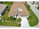 Well maintained single-story home with a brown roof, landscaped yard, and long driveway at 1701 Lastingham Ln, Port Charlotte, FL 33980