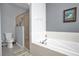Bathroom showcasing a soaking tub with a tiled backsplash and glass-enclosed shower at 1701 Lastingham Ln, Port Charlotte, FL 33980