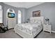 Charming bedroom with a TV, white dresser, and large windows providing natural light at 1701 Lastingham Ln, Port Charlotte, FL 33980