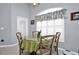 Bright breakfast nook with a glass table, comfortable seating, and a view of the garden at 1701 Lastingham Ln, Port Charlotte, FL 33980