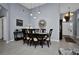 Cozy dining room with seating for six, accented by a stylish mirror and chandelier at 1701 Lastingham Ln, Port Charlotte, FL 33980