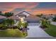 Charming single-story home with well-manicured landscaping and a spacious driveway leading to a two-car garage at 1701 Lastingham Ln, Port Charlotte, FL 33980