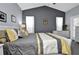 Serene main bedroom featuring gray walls, a white bed frame, and decorative pillows at 1701 Lastingham Ln, Port Charlotte, FL 33980