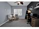 Comfortable home office featuring neutral walls, a ceiling fan, a desk, and two comfortable armchairs at 1701 Lastingham Ln, Port Charlotte, FL 33980