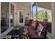 Cozy sunroom featuring comfortable seating, a colorful rug, and views of the outdoors at 1701 Lastingham Ln, Port Charlotte, FL 33980