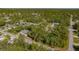 Aerial view of a home surrounded by lush greenery, situated in a tranquil neighborhood with a peaceful atmosphere at 17380 Shirley Ave, Port Charlotte, FL 33948