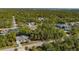 Aerial view of a home surrounded by lush greenery, showcasing its peaceful setting and community neighborhood at 17380 Shirley Ave, Port Charlotte, FL 33948