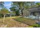 Spacious backyard with a screened-in patio, ideal for relaxation and outdoor entertaining near mature trees at 17380 Shirley Ave, Port Charlotte, FL 33948