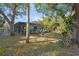 The backyard features an enclosed in ground pool and lots of trees at 17380 Shirley Ave, Port Charlotte, FL 33948