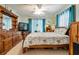 Comfortable bedroom with wood furniture and floral-patterned bedding, creating a cozy and inviting atmosphere at 17380 Shirley Ave, Port Charlotte, FL 33948