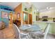 Bright dining area with a glass table, wicker chairs and views to other rooms at 17380 Shirley Ave, Port Charlotte, FL 33948
