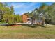 Charming home with mature trees and landscaped front yard, blending curb appeal with a touch of nature at 17380 Shirley Ave, Port Charlotte, FL 33948