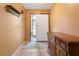 Inviting foyer with ceramic tile flooring, neutral paint, and a coat rack for added convenience at 17380 Shirley Ave, Port Charlotte, FL 33948