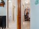 Hallway view showcasing the bathroom and a well-organized walk-in closet with abundant storage space at 17380 Shirley Ave, Port Charlotte, FL 33948