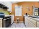 Functional kitchen featuring white cabinets, stainless steel appliances, and tile flooring at 17380 Shirley Ave, Port Charlotte, FL 33948